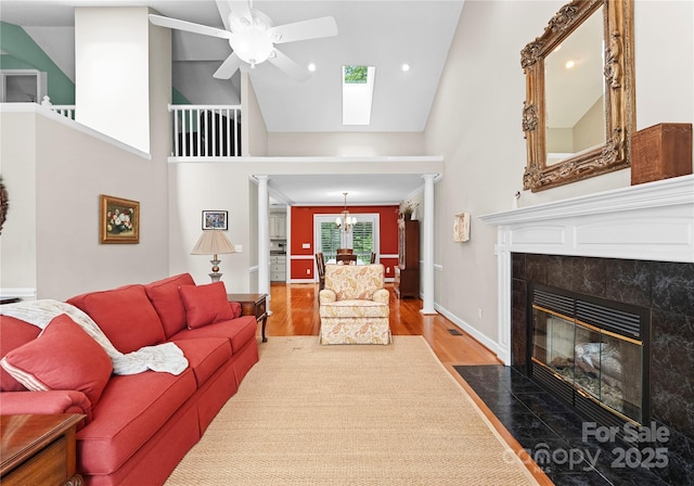 4101 Fairway Downs Ct Unit 9, Charlotte, NC 28277 - living room with high vaulted ceiling, ceiling fan, wood finished floors, a tile fireplace, and a skylight