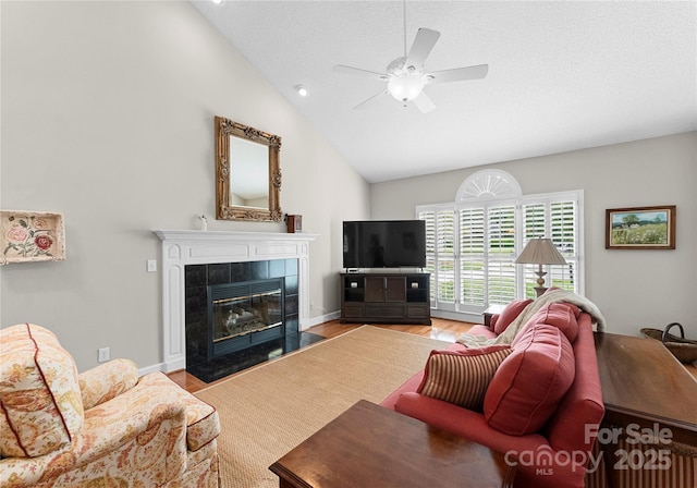 4101 Fairway Downs Ct Unit 9, Charlotte, NC 28277 - living area featuring a fireplace, ceiling fan, high vaulted ceiling, wood finished floors, and baseboards