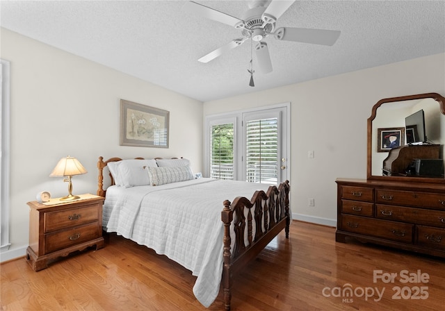 4101 Fairway Downs Ct Unit 9, Charlotte, NC 28277 - bedroom with access to outside, light wood-style flooring, a textured ceiling, baseboards, and a ceiling fan