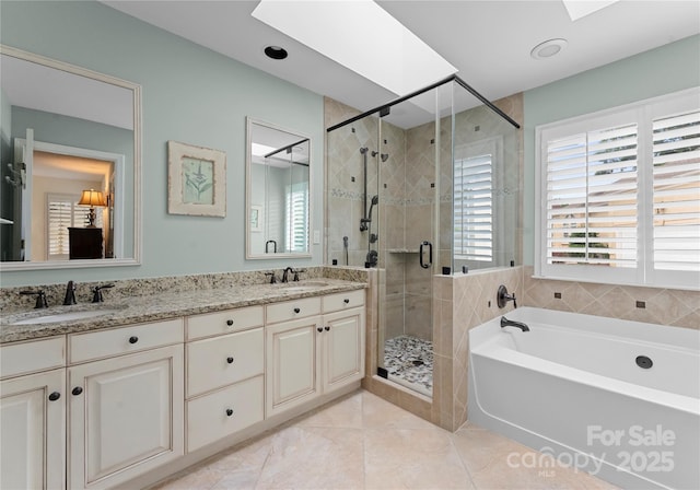 4101 Fairway Downs Ct Unit 9, Charlotte, NC 28277 - bathroom with a skylight, a garden tub, double vanity, a stall shower, and tile patterned floors