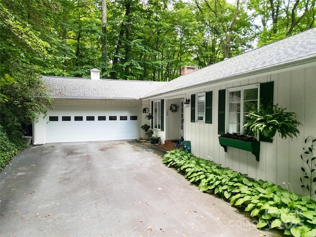 168 River Ridge Rd, Brevard, NC 28712 - ranch-style house featuring a chimney, asphalt driveway, and an attached garage