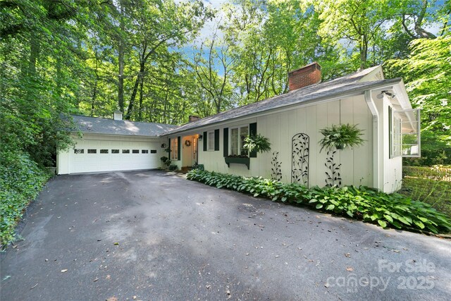 168 River Ridge Rd, Brevard, NC 28712 - ranch-style house with a chimney, driveway, and an attached garage