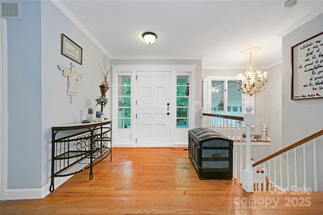 168 River Ridge Rd, Brevard, NC 28712 - entryway featuring wood finished floors, ornamental molding, and a chandelier