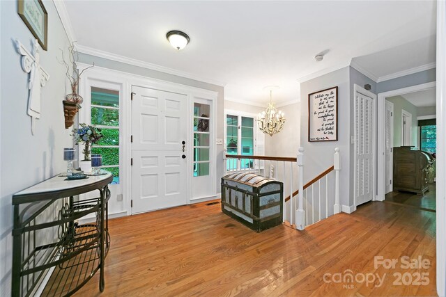 168 River Ridge Rd, Brevard, NC 28712 - foyer featuring wood finished floors, a chandelier, and ornamental molding