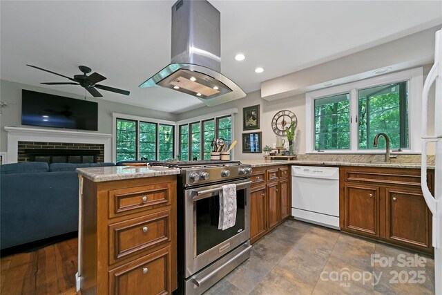 168 River Ridge Rd, Brevard, NC 28712 - kitchen with dishwasher, gas stove, island range hood, a peninsula, and brown cabinets