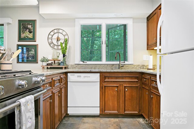 168 River Ridge Rd, Brevard, NC 28712 - kitchen featuring white appliances, brown cabinetry, light stone counters, and dark stone finish floors