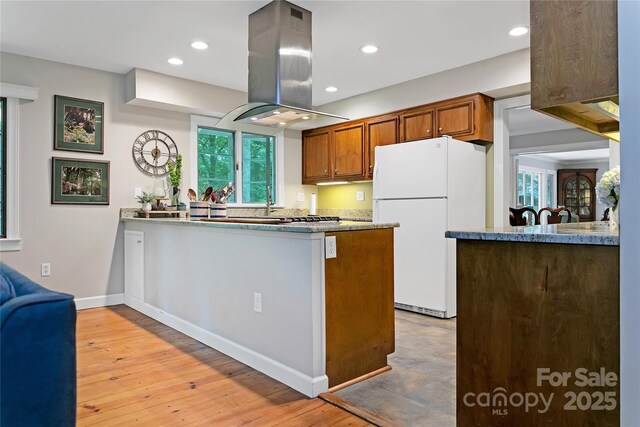 168 River Ridge Rd, Brevard, NC 28712 - kitchen with freestanding refrigerator, island exhaust hood, a peninsula, light wood-style floors, and recessed lighting