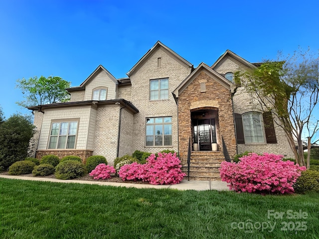 324 Squash Harvest Ct, Matthews, NC 28104 - french country inspired facade with brick siding, a front lawn, and stone siding