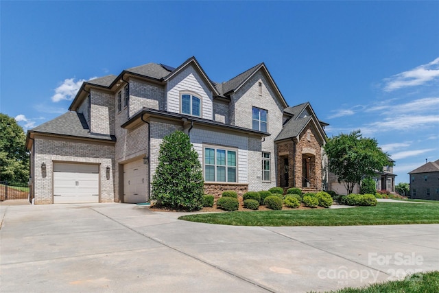 324 Squash Harvest Ct, Matthews, NC 28104 - view of front facade with concrete driveway, a front yard, solar panels, brick siding, and a garage