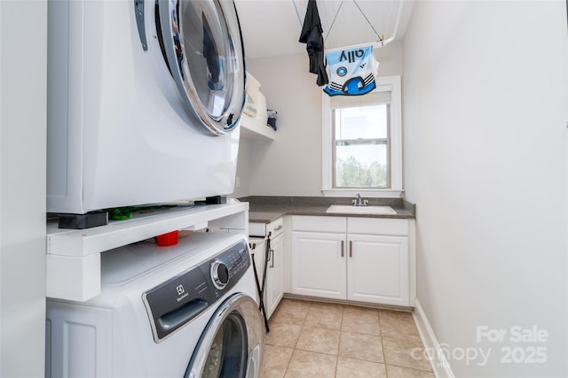 324 Squash Harvest Ct, Matthews, NC 28104 - laundry room with cabinet space, estacked washer and dryer, and light tile patterned flooring