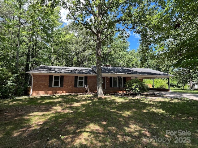 511 Evelyn Ave, Kannapolis, NC 28083 - single story home with brick siding, a front lawn, an attached carport, and driveway