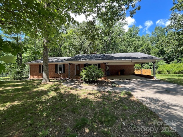 511 Evelyn Ave, Kannapolis, NC 28083 - ranch-style house featuring concrete driveway, brick siding, a carport, and a front lawn