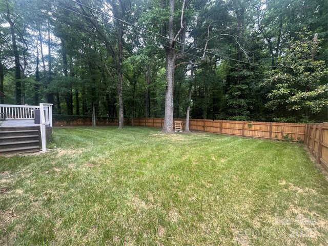 511 Evelyn Ave, Kannapolis, NC 28083 - view of yard featuring a wooden deck and a view of trees