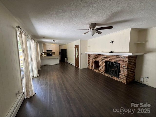 511 Evelyn Ave, Kannapolis, NC 28083 - unfurnished living room with a baseboard radiator, dark wood-style floors, a textured ceiling, a brick fireplace, and ceiling fan