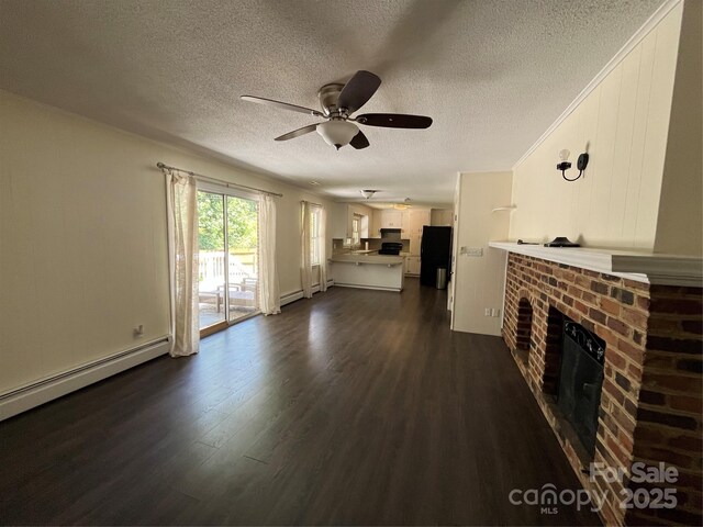 511 Evelyn Ave, Kannapolis, NC 28083 - unfurnished living room featuring a fireplace, a textured ceiling, a ceiling fan, dark wood-style flooring, and a baseboard radiator