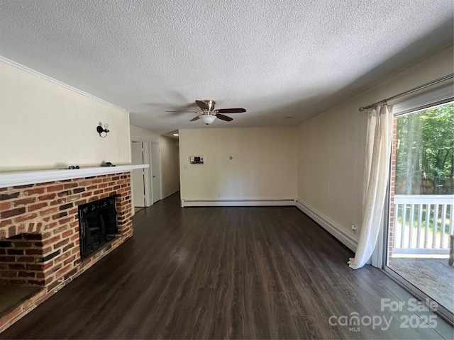 511 Evelyn Ave, Kannapolis, NC 28083 - unfurnished living room with dark wood-style flooring, ceiling fan, a textured ceiling, a brick fireplace, and a baseboard radiator