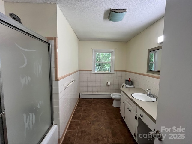 511 Evelyn Ave, Kannapolis, NC 28083 - full bathroom with tile walls, wainscoting, a baseboard radiator, vanity, and toilet