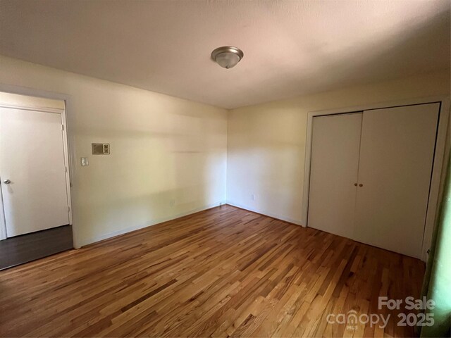 511 Evelyn Ave, Kannapolis, NC 28083 - unfurnished bedroom with wood finished floors and a closet