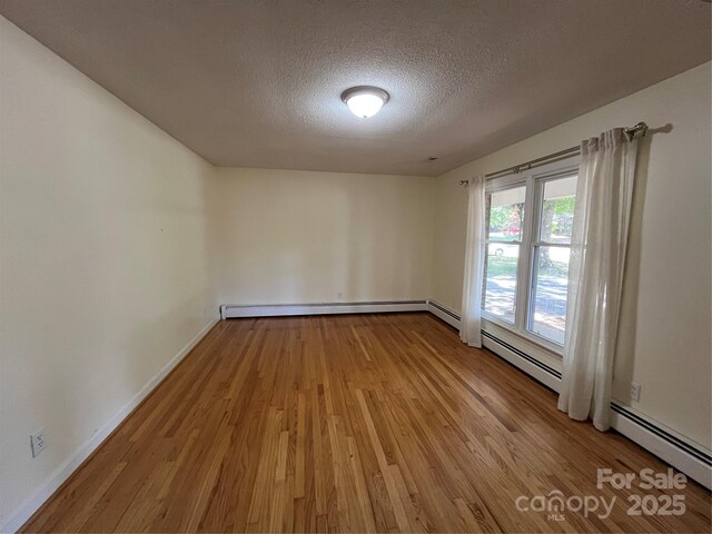511 Evelyn Ave, Kannapolis, NC 28083 - unfurnished room with wood finished floors, a textured ceiling, and baseboards