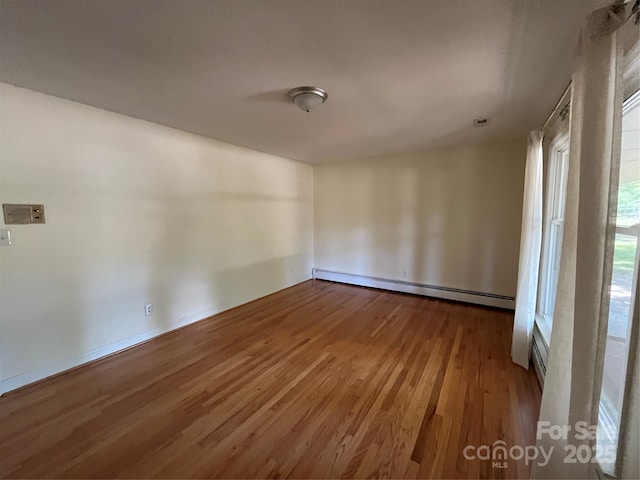 511 Evelyn Ave, Kannapolis, NC 28083 - spare room with a baseboard heating unit and wood finished floors