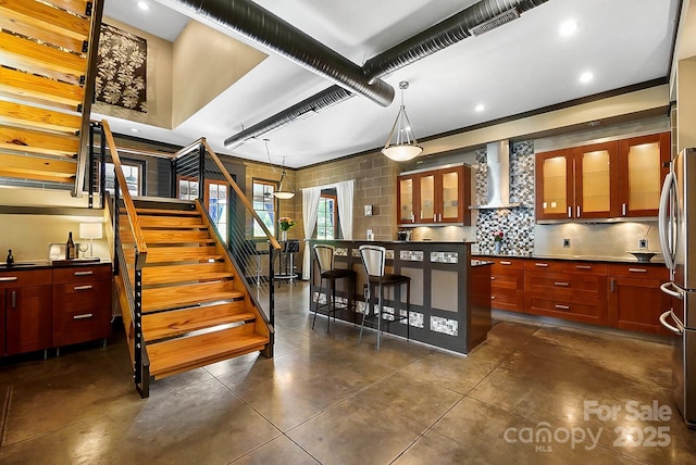 14701 Cabarrus Rd, Mint Hill, NC 28227 - kitchen with wall chimney exhaust hood, decorative backsplash, glass insert cabinets, reddish brown cabinets, and recessed lighting