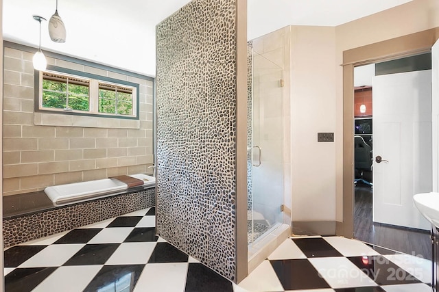 14701 Cabarrus Rd, Mint Hill, NC 28227 - bathroom with a shower stall, tile patterned floors, tiled bath, and tile walls