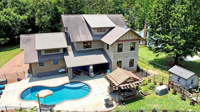14701 Cabarrus Rd, Mint Hill, NC 28227 - rear view of property featuring stone siding, a patio, and roof with shingles
