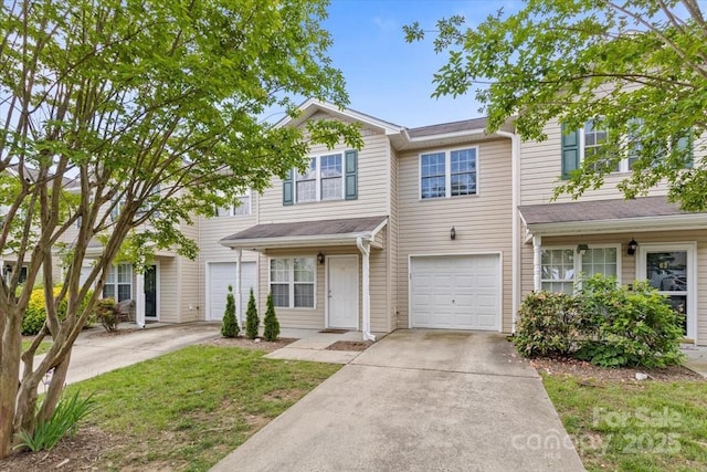 townhome / multi-family property with driveway and a garage