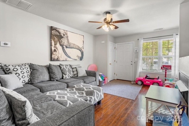 living room featuring dark wood-style floors and ceiling fan