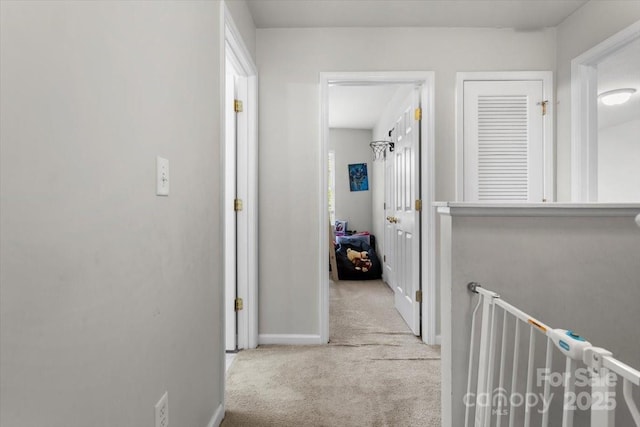 corridor featuring carpet and baseboards