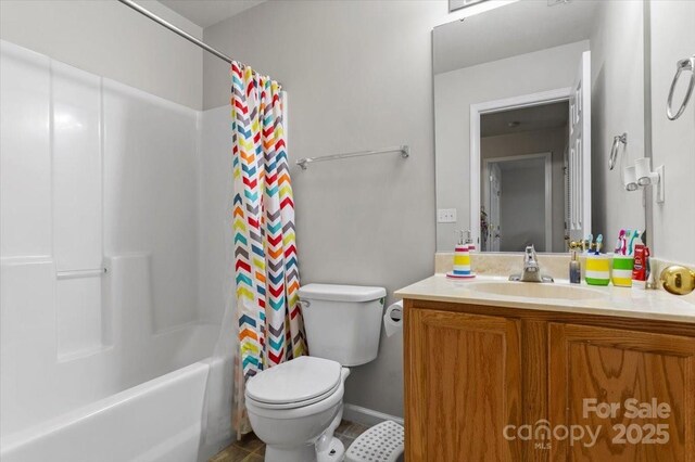 bathroom with toilet, vanity, shower / bath combo with shower curtain, and tile patterned flooring