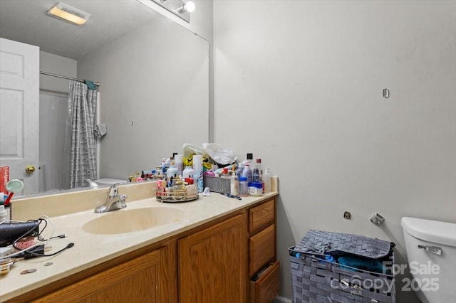 bathroom with toilet, vanity, and a shower with curtain