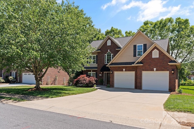 3124 17th Street Ln NE, Hickory, NC 28601 - view of front facade featuring driveway, a garage, brick siding, and a front yard