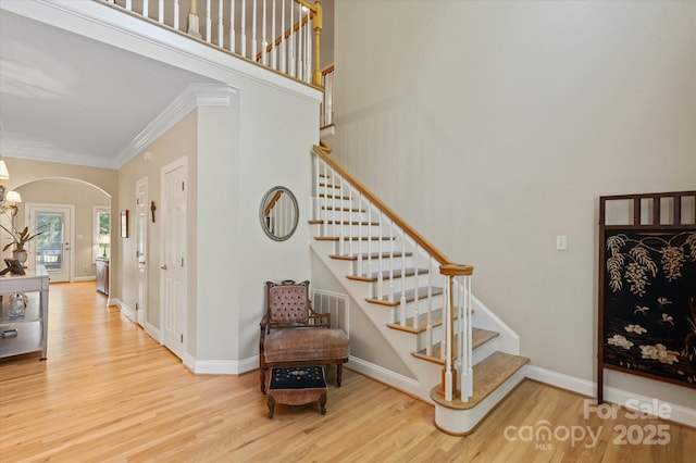 3124 17th Street Ln NE, Hickory, NC 28601 - staircase featuring arched walkways, wood finished floors, crown molding, and baseboards
