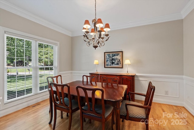 3124 17th Street Ln NE, Hickory, NC 28601 - dining area with a chandelier, light wood-style floors, ornamental molding, and wainscoting
