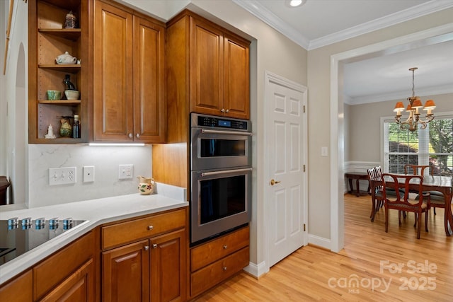 3124 17th Street Ln NE, Hickory, NC 28601 - kitchen featuring stainless steel double oven, brown cabinets, a chandelier, light wood finished floors, and black electric cooktop