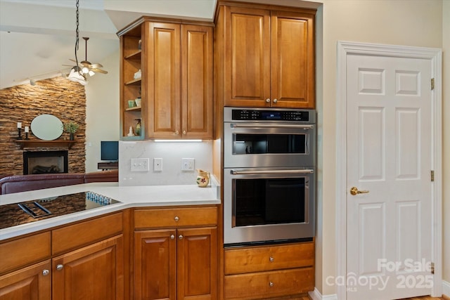 3124 17th Street Ln NE, Hickory, NC 28601 - kitchen featuring double oven, a fireplace, brown cabinets, and light countertops