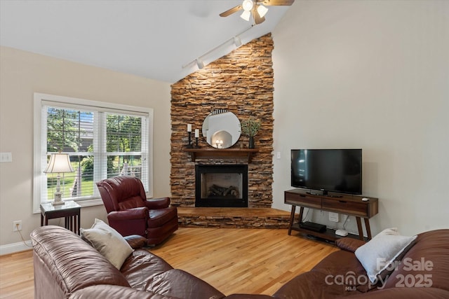 3124 17th Street Ln NE, Hickory, NC 28601 - living area featuring light wood-style floors, a fireplace, a ceiling fan, baseboards, and high vaulted ceiling