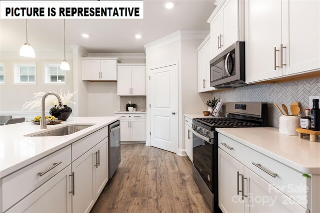 121 S Shayna Rd, Troutman, NC 28166 - kitchen with appliances with stainless steel finishes, a sink, tasteful backsplash, white cabinets, and crown molding