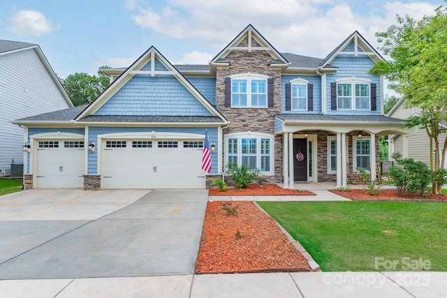 3666 Jacinta Ct, Tega Cay, SC 29708 - craftsman house with stone siding, a front lawn, driveway, and a garage
