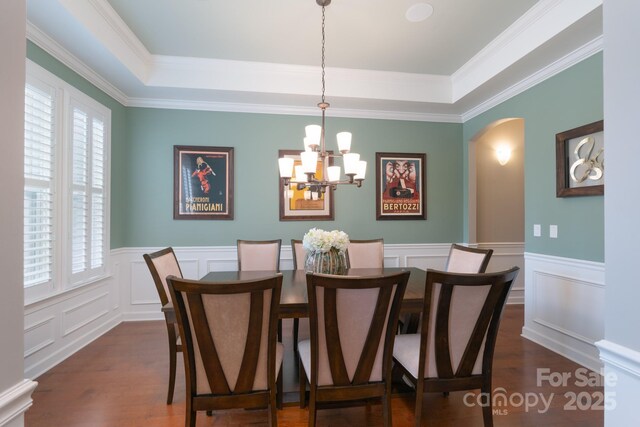 3666 Jacinta Ct, Tega Cay, SC 29708 - dining room with dark wood-type flooring, a decorative wall, arched walkways, a chandelier, and a tray ceiling