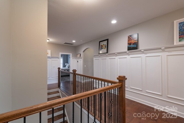 3666 Jacinta Ct, Tega Cay, SC 29708 - hall with an upstairs landing, a decorative wall, dark wood-style flooring, arched walkways, and recessed lighting