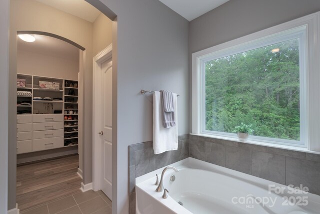 3666 Jacinta Ct, Tega Cay, SC 29708 - bathroom with a garden tub, tile patterned floors, and a spacious closet