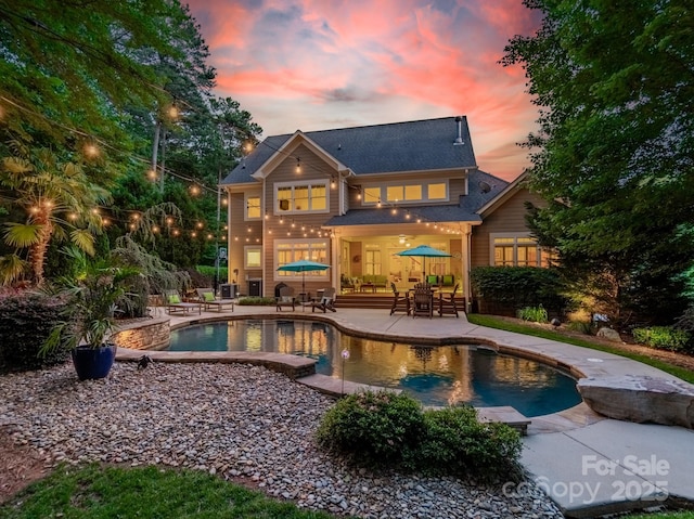 4319 Sailview Dr, Denver, NC 28037 - back of house at dusk featuring a patio area and an outdoor pool