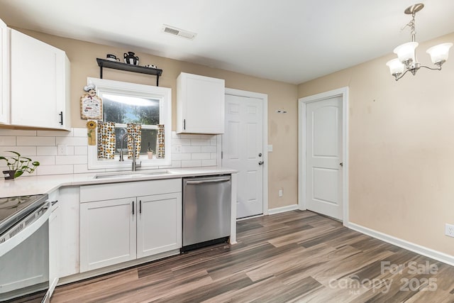 319 Leonard Ave, Albemarle, NC 28001 - kitchen with appliances with stainless steel finishes, a sink, a chandelier, and wood finished floors