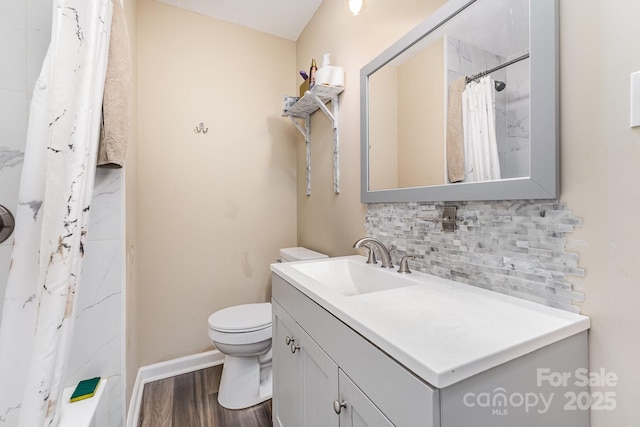 319 Leonard Ave, Albemarle, NC 28001 - full bath featuring decorative backsplash, vanity, toilet, wood finished floors, and a shower with shower curtain