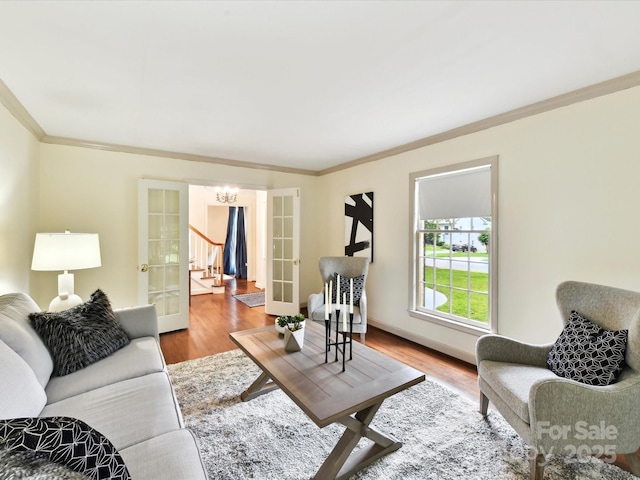 1049 Regency Dr, Charlotte, NC 28211 - living room with ornamental molding, a chandelier, wood finished floors, french doors, and baseboards