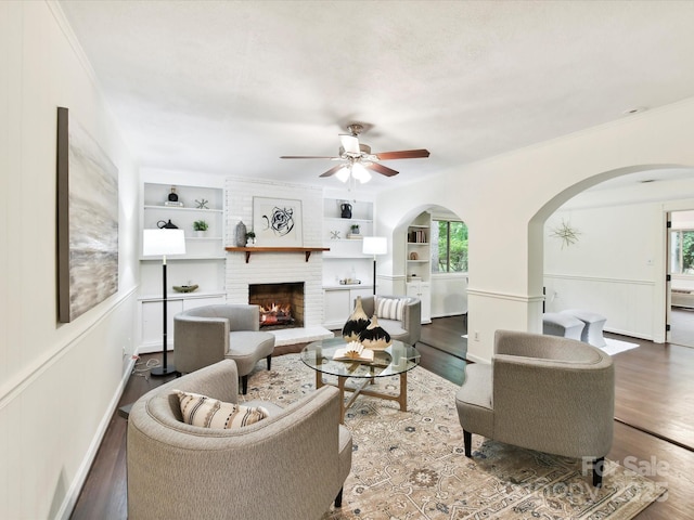 1049 Regency Dr, Charlotte, NC 28211 - living area featuring arched walkways, ceiling fan, wood finished floors, and ornamental molding