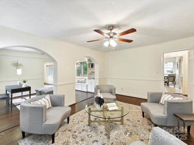 1049 Regency Dr, Charlotte, NC 28211 - living area featuring arched walkways, a ceiling fan, and wood finished floors