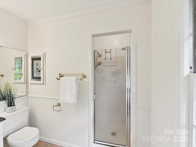 1049 Regency Dr, Charlotte, NC 28211 - full bathroom with a shower stall, ornamental molding, a wainscoted wall, and toilet